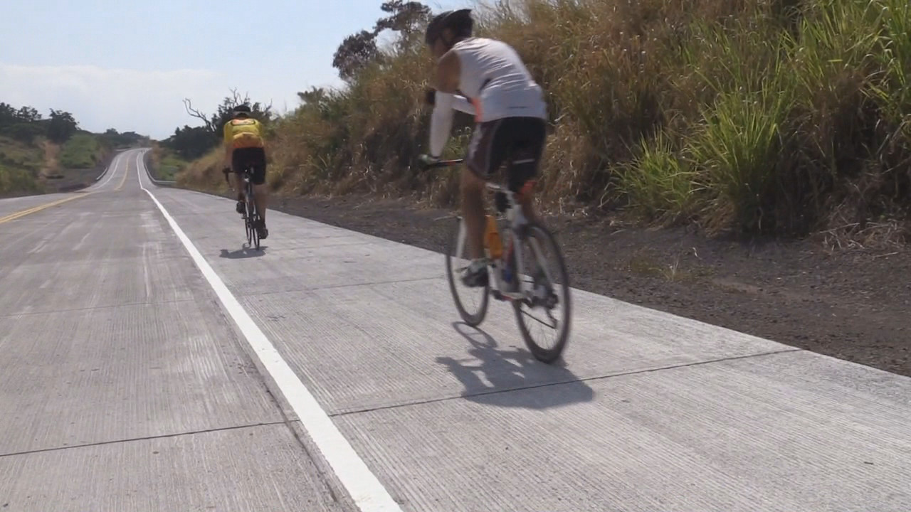 Cyclists ride over the newly opened road in South Kona.