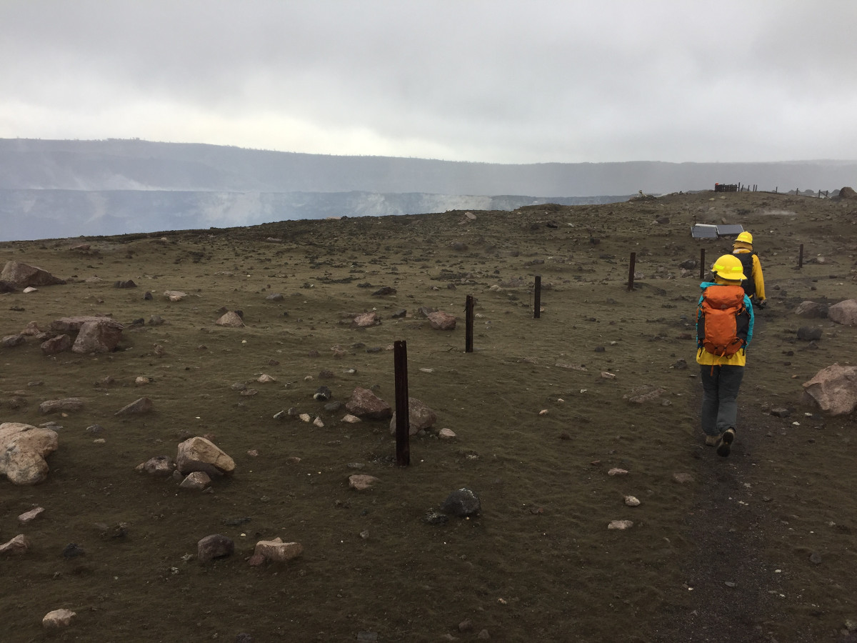 (USGS photo) HVO scientists visited the rim of Halemaʻumaʻu this afternoon (11/28) to collect samples of tephra and check for equipment damage. This view, taken on the approach to the Halemaʻumaʻu, shows the tephra deposit on the crater rim. New spatter is seen as dark lumps scattered across the center of the image on top of older brown-colored Pele's hair.