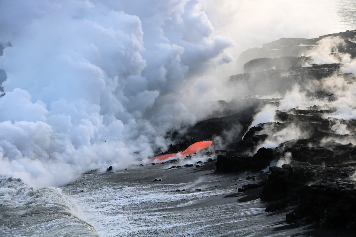 (USGS photo) A close-up of one of several streams of lava entering the ocean at the front of the Kamokuna lava delta on Kīlauea's south flank. USGS notes that  "the billowy white plume formed by the interaction of hot lava and seawater may look harmless, but it is a mixture of superheated steam, hydrochloric acid, and tiny shards of volcanic glass—all of which should be avoided."