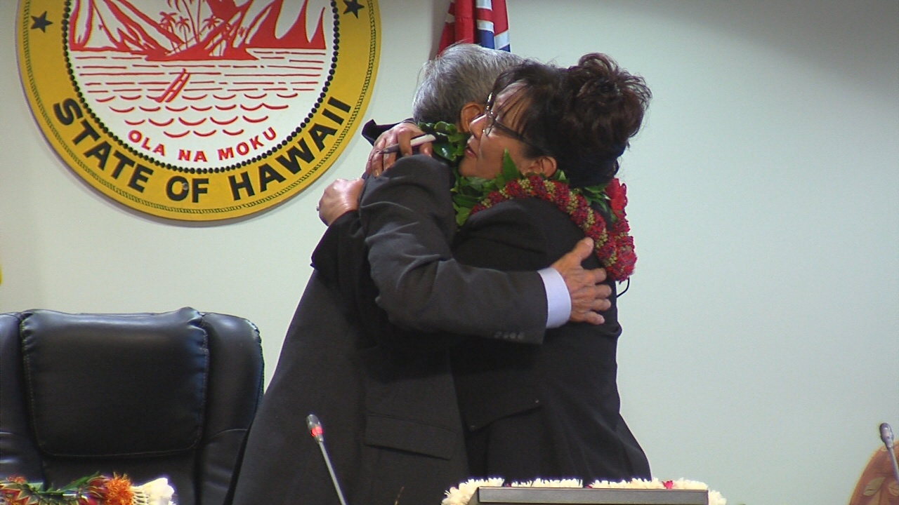 Mayor Harry Kim embraces Council Chair Valerie Poindexter.